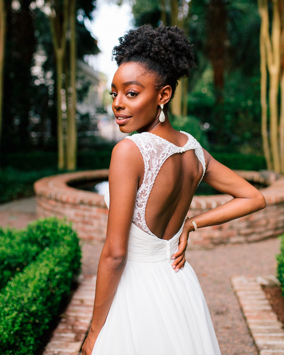 bride in beaded wedding dress with open back