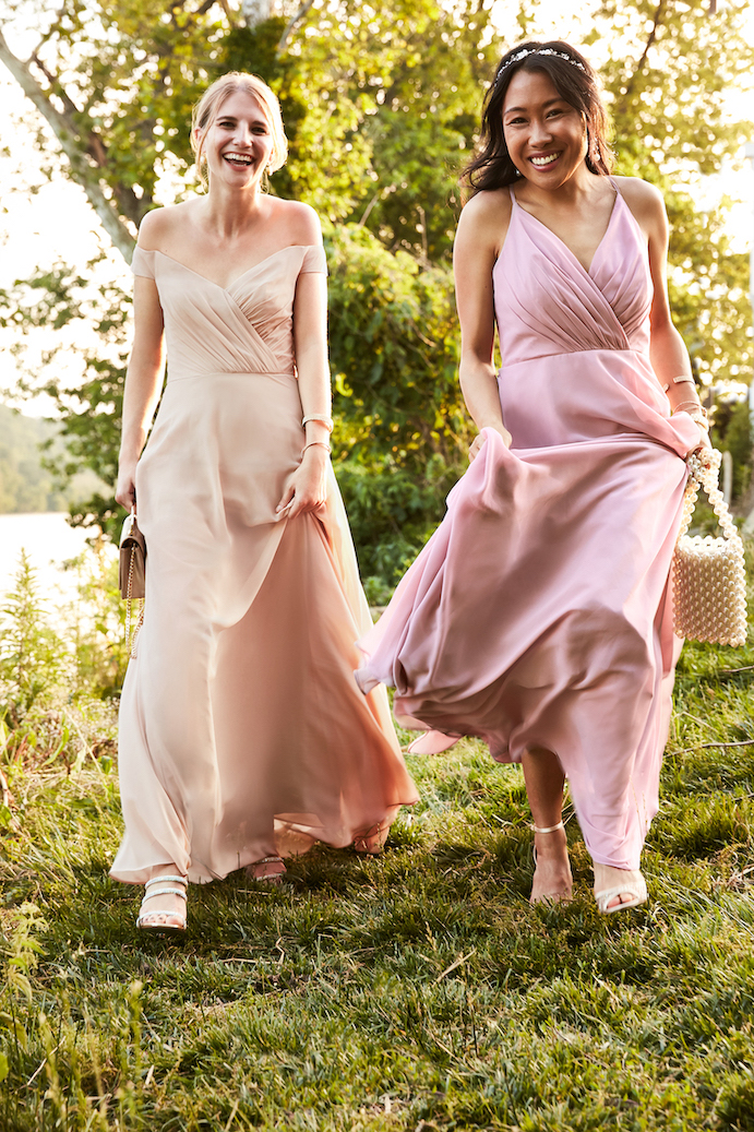 Two girls running and smiling in fall bridesmaid dresses