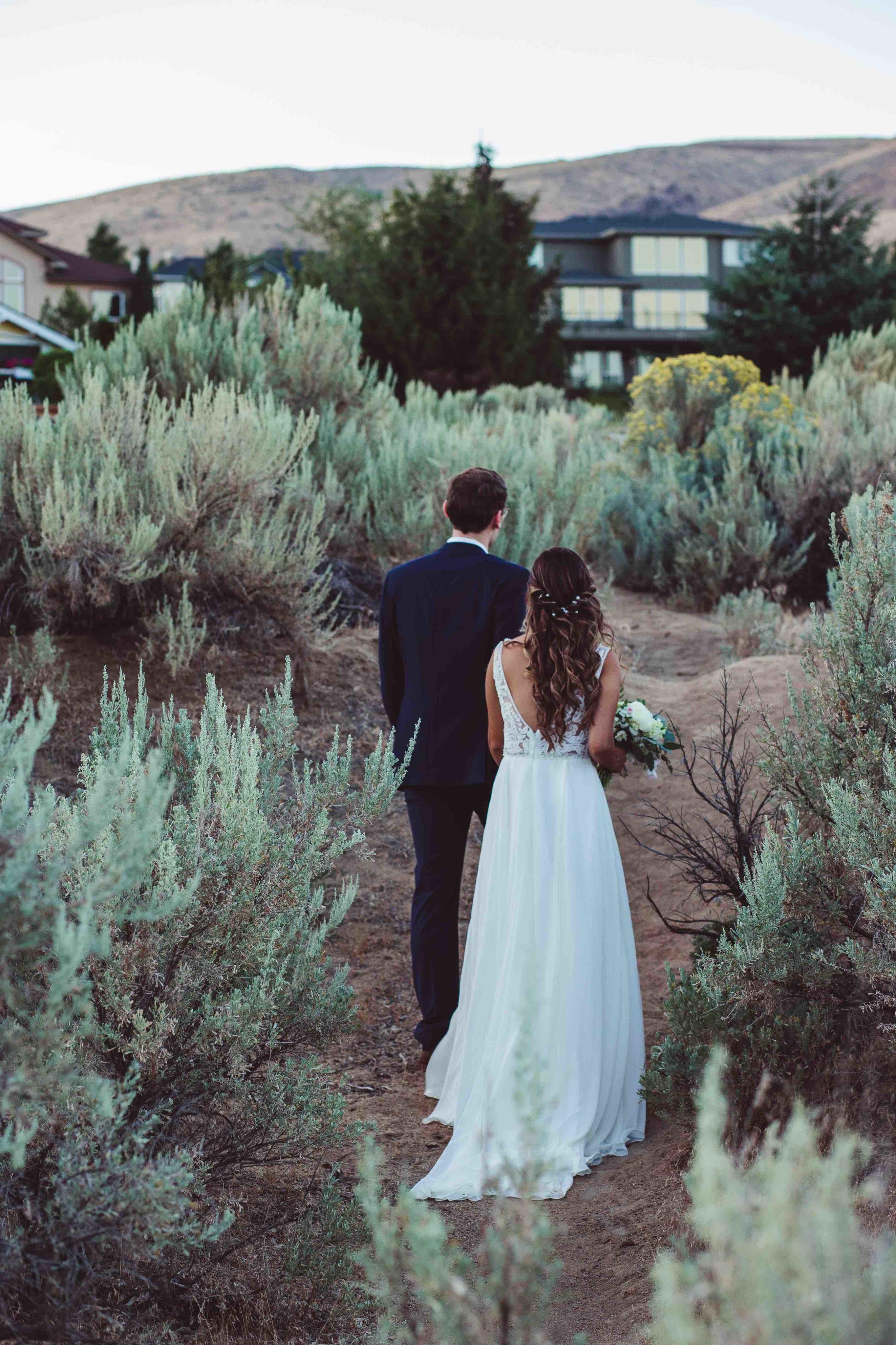 Bride and groom holding hands and walking away