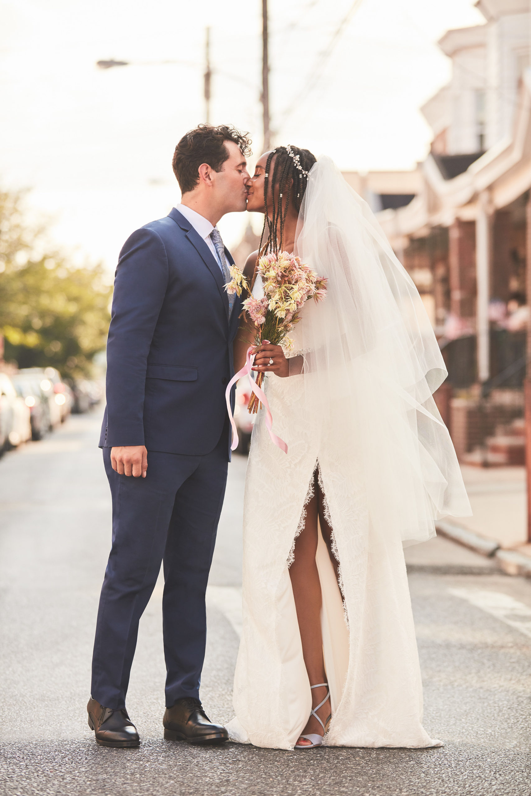 Bride and Groom kissing in the city streets