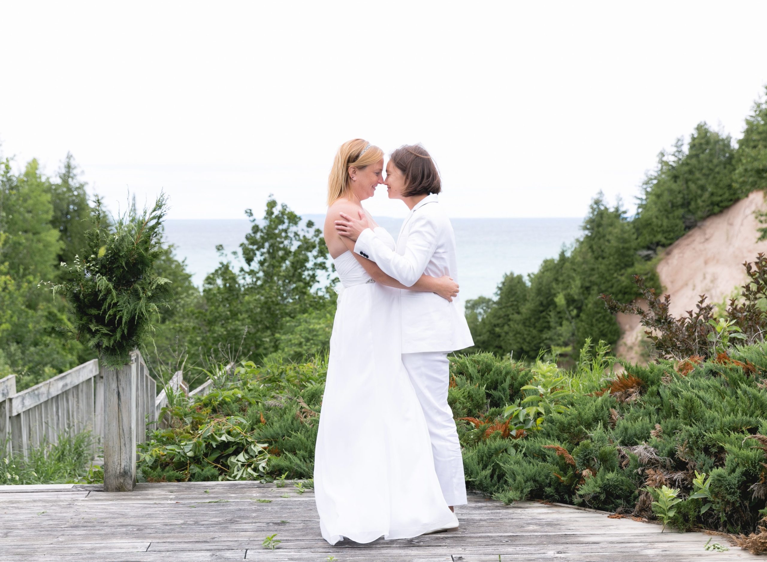 Rachel and Sarah embracing in front of Lake Michigan