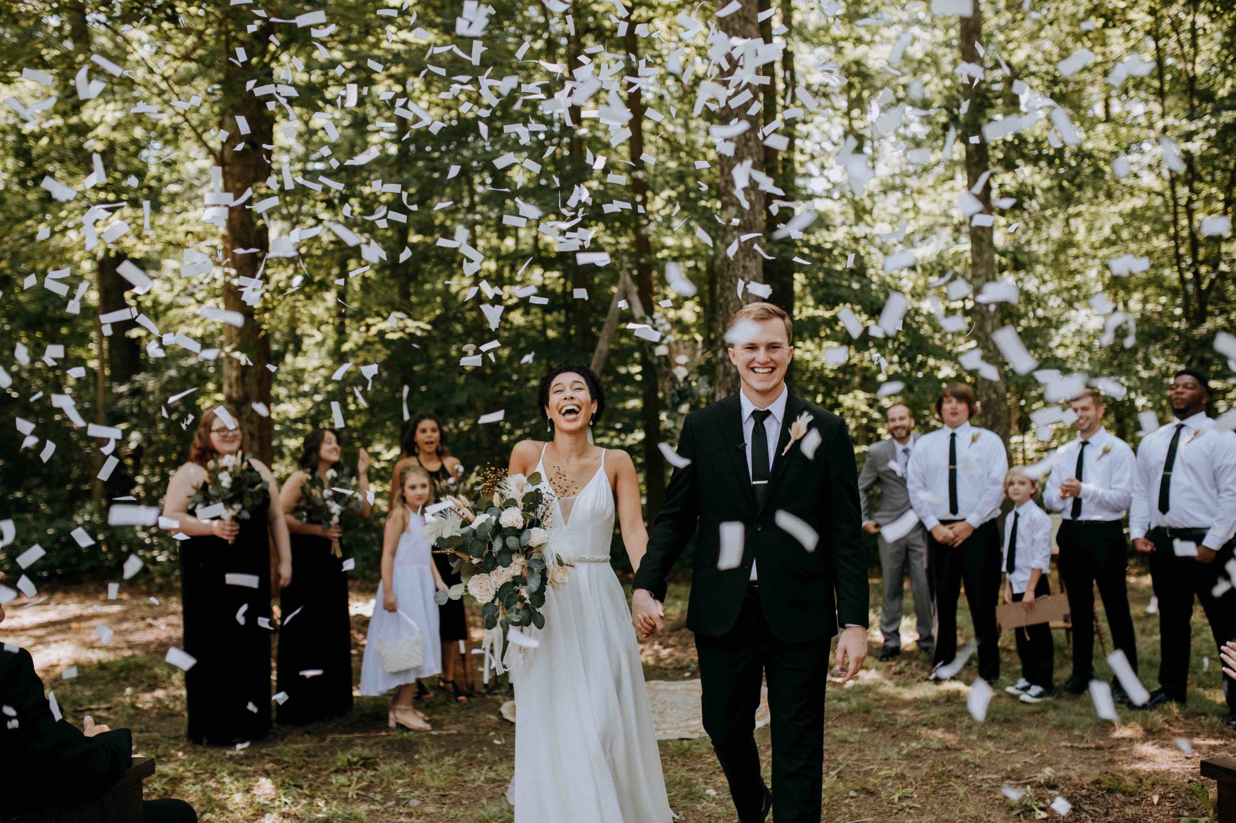 Confetti falling on bride and groom after the wedding ceremony
