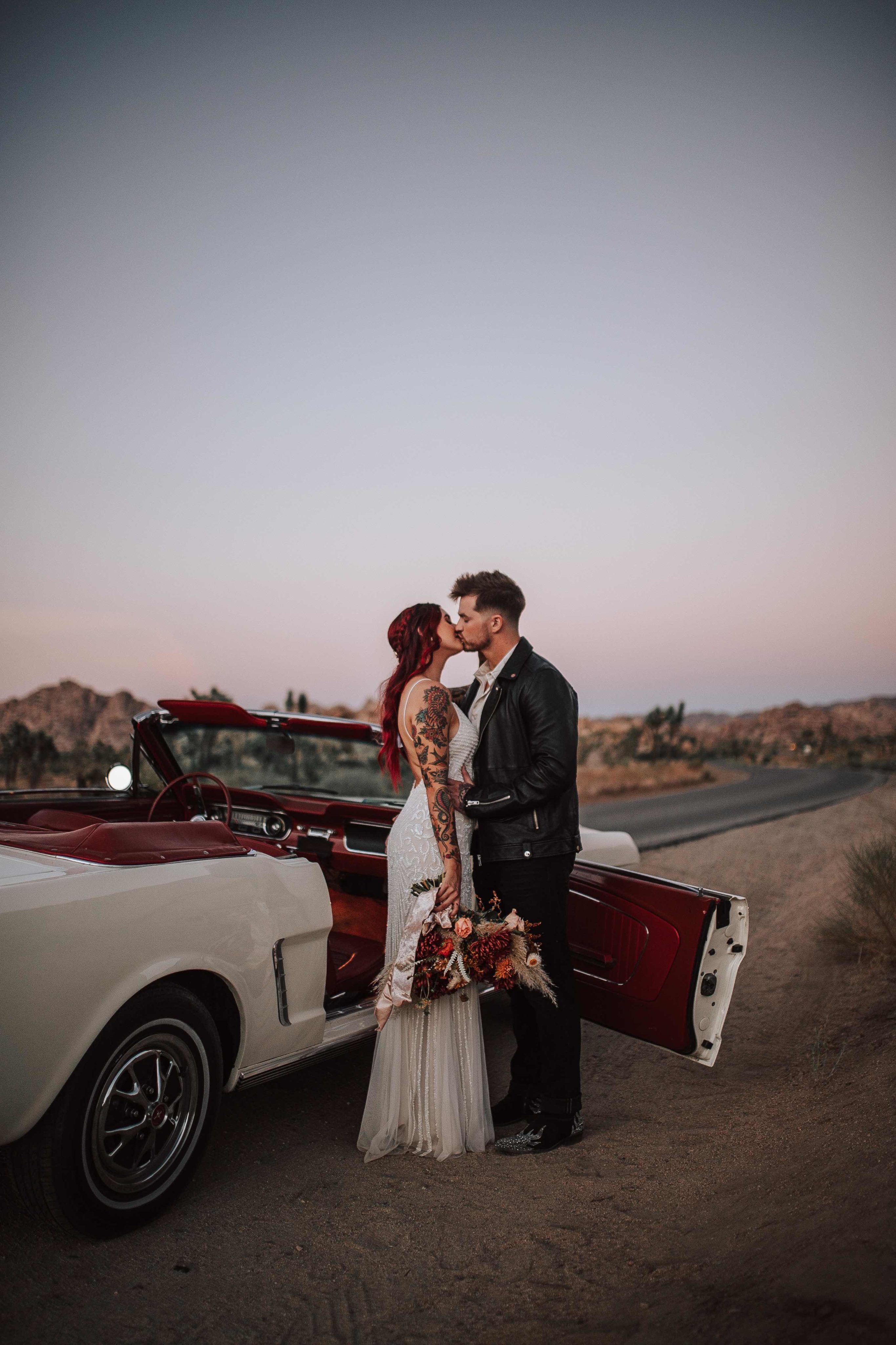 Bride Jordan and Groom Tylar kissing at sunset at Joshua Tree