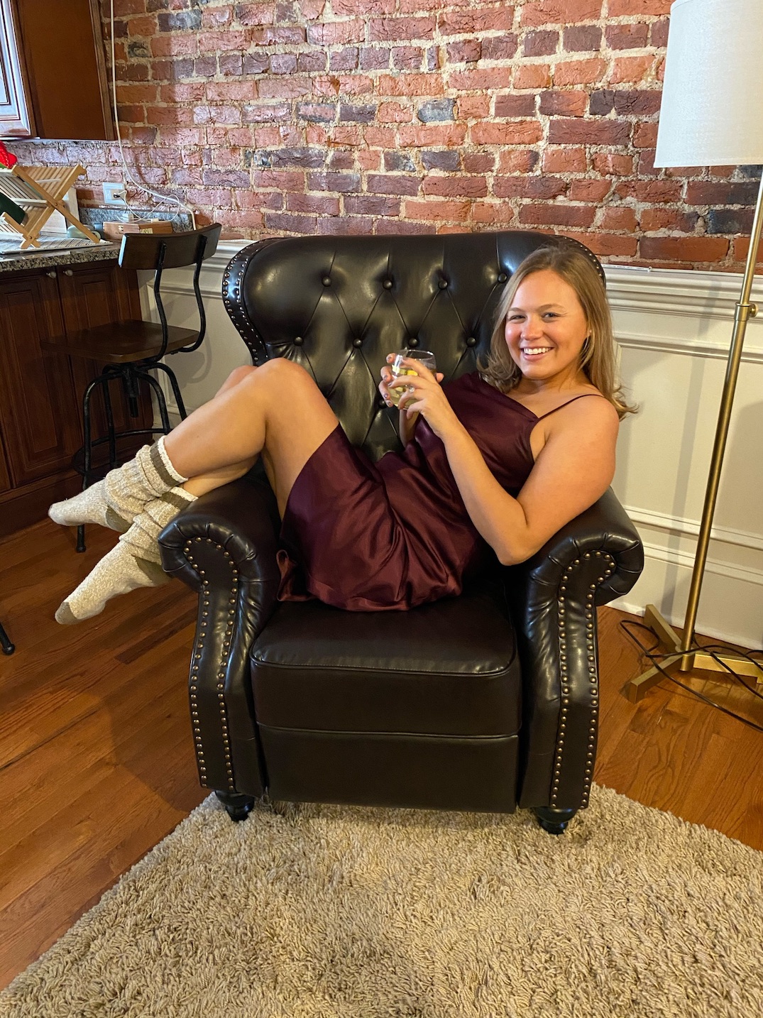 Girl sitting on chair with glass of wine