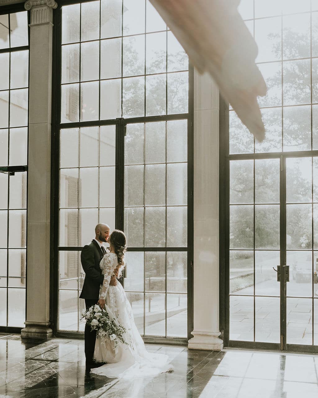 bride and groom kissing in venue