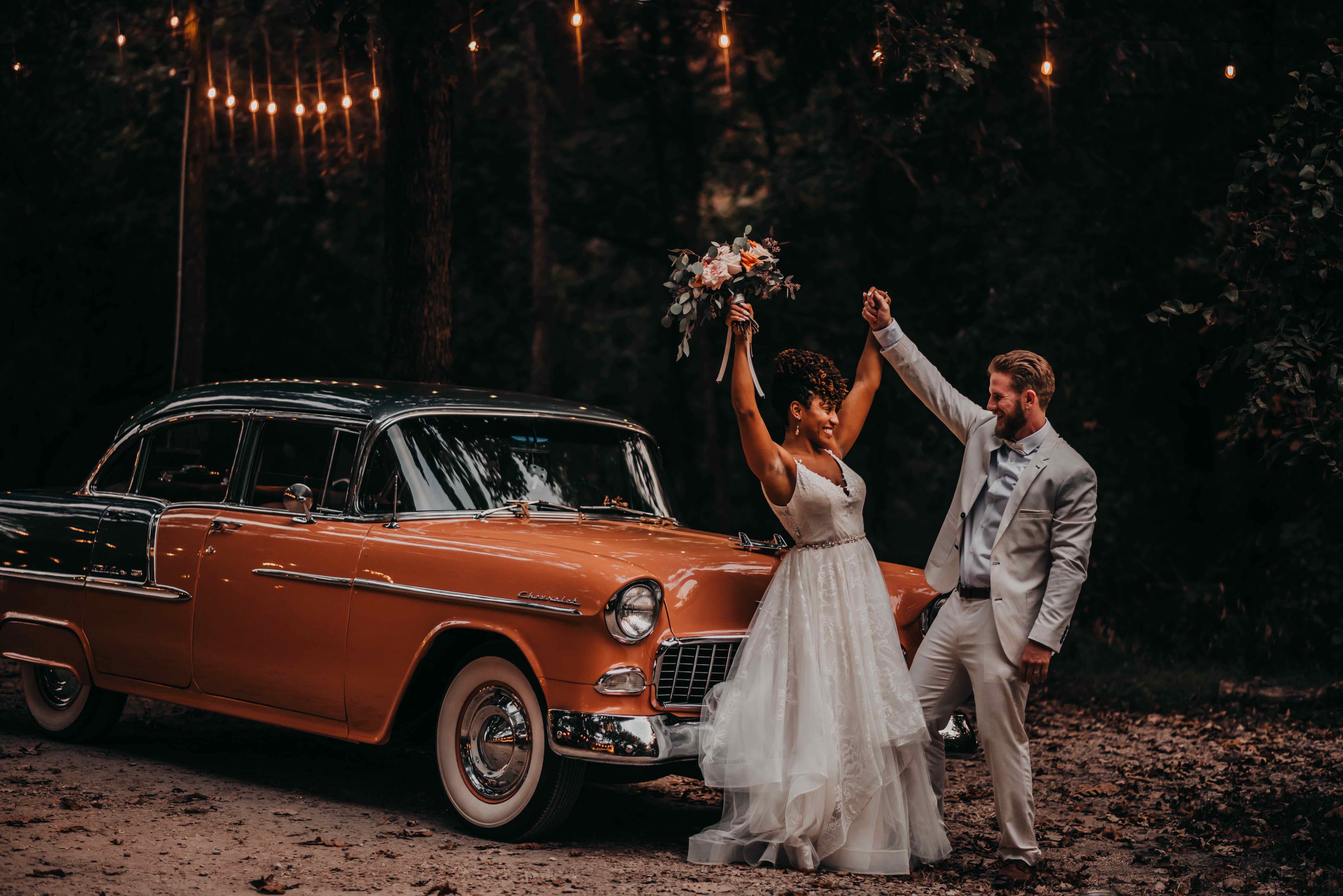 Bride and groom with vintage car