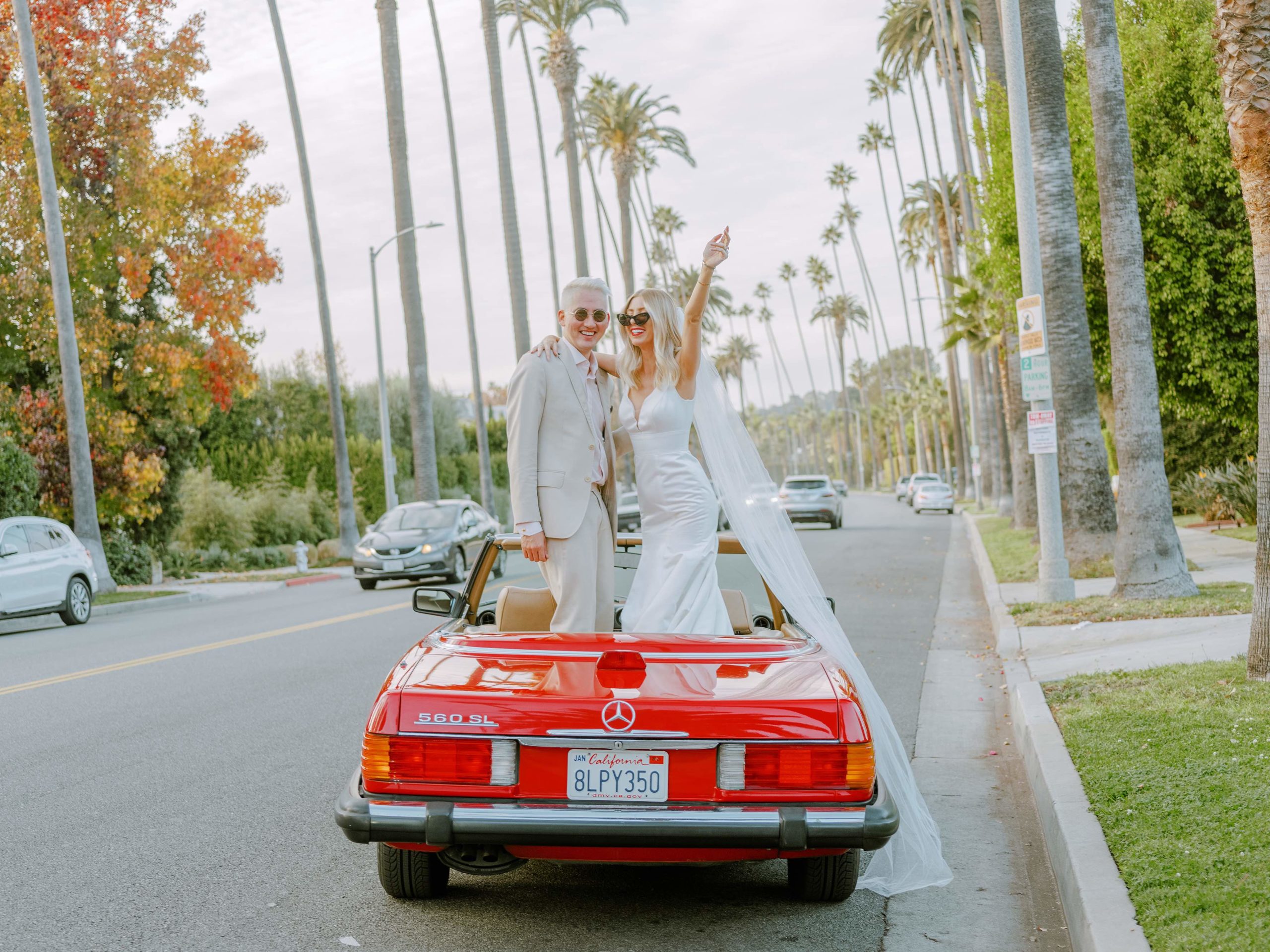 couple dancing in red convertible