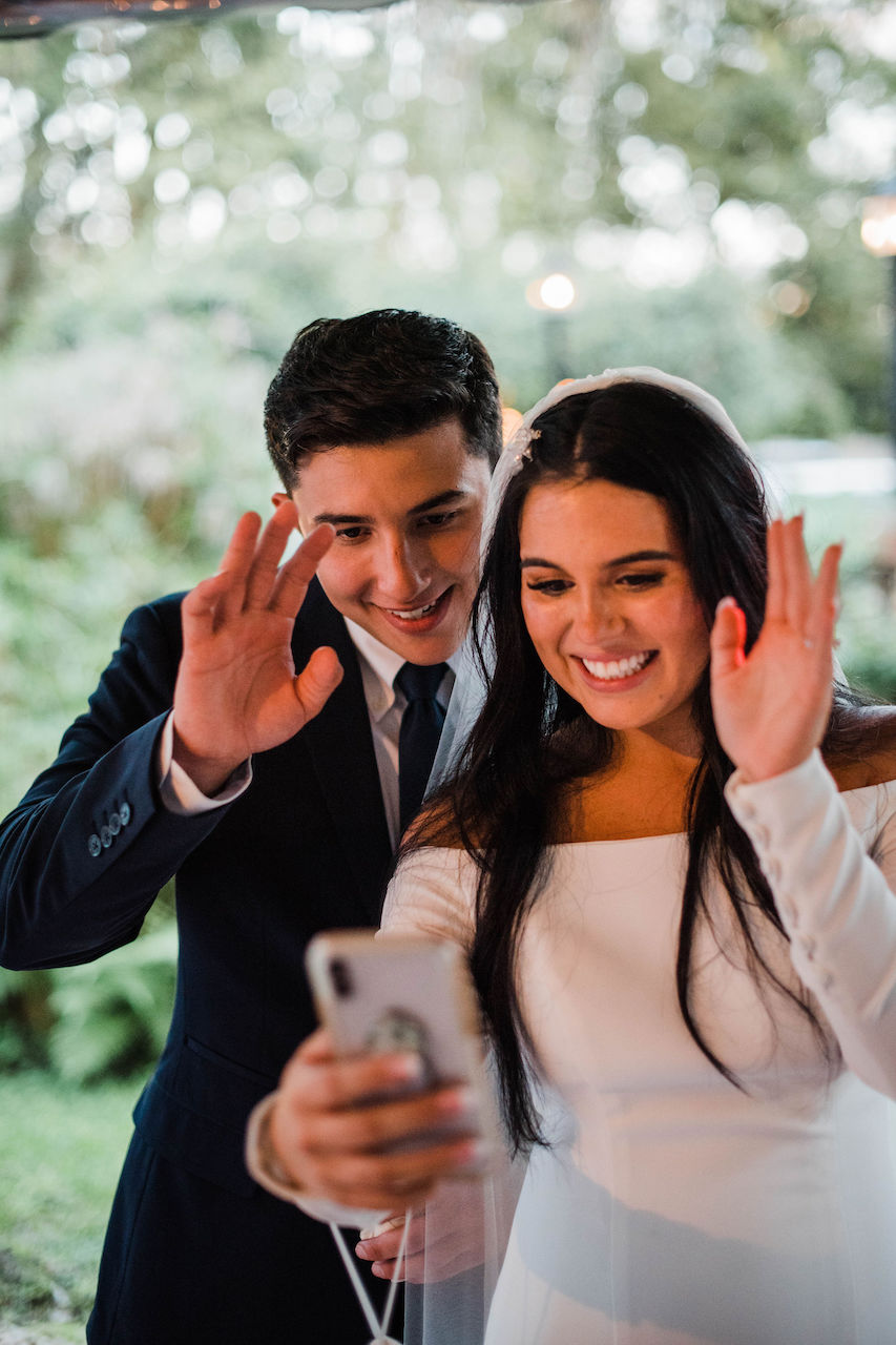 bride and groom on facetime at their intimate and romantic wedding in Florida