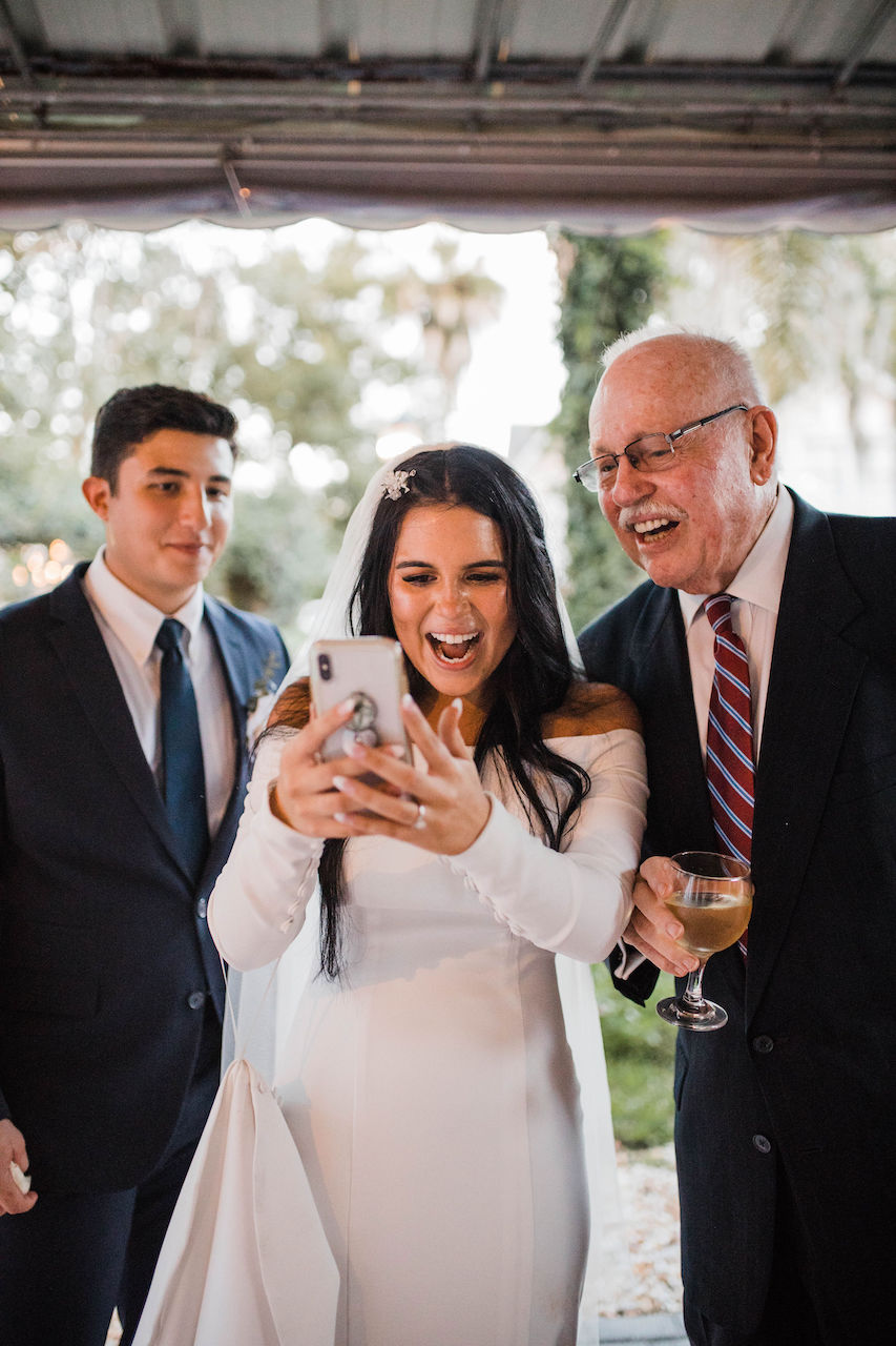 bride and groom on facetime at their intimate and romantic wedding in Florida