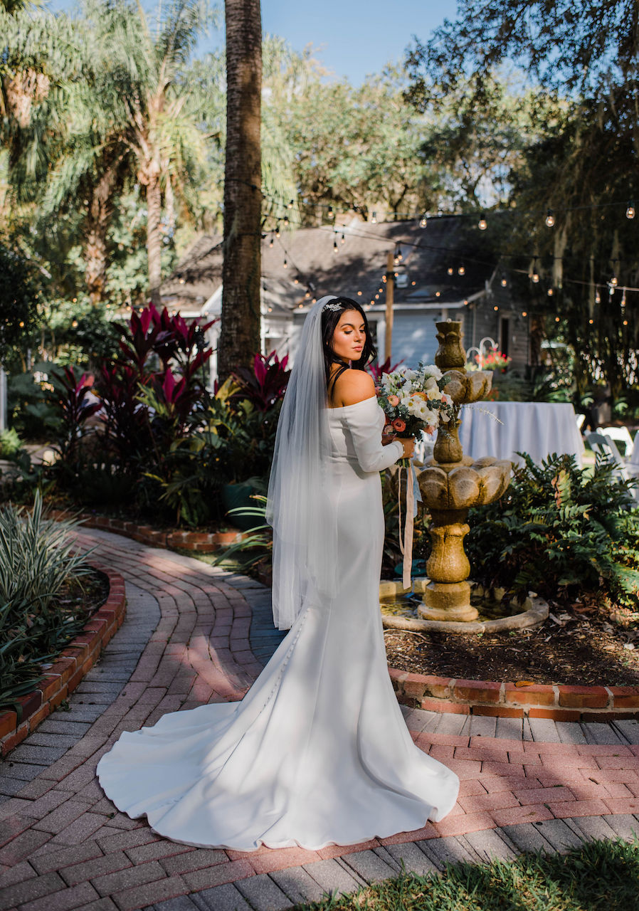 bride in mermaid wedding dress with button detailing down the back