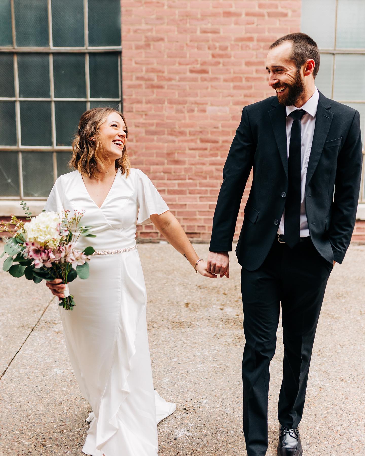 bride and groom walking hand in hand