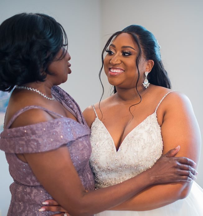 Mother of the bride and bride embracing