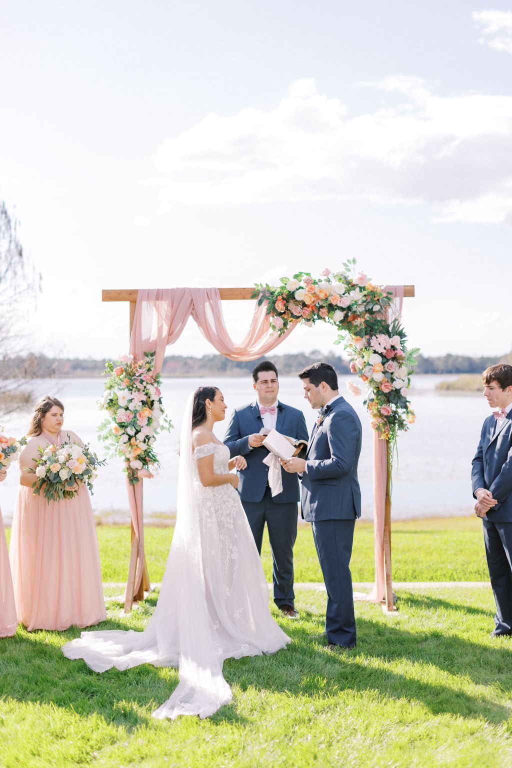 bride and groom being married by groom's brother at their bright and airy springtime wedding 