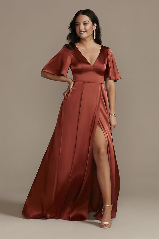 Women in a flowy burnt orange bridesmaid dress with flutter-sleeves