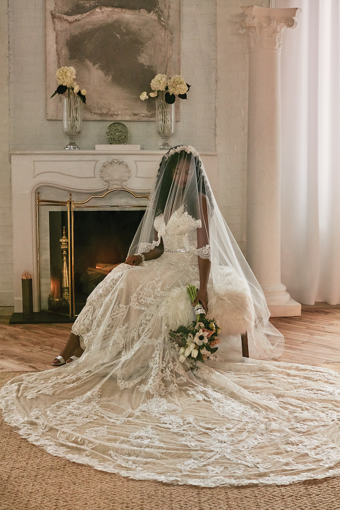 bride wearing embellished wedding dress with cathedral length train 