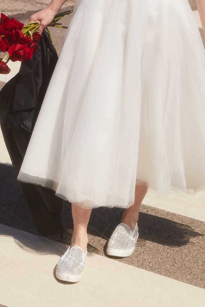 bride walking down city street in crystal slip on sneakers