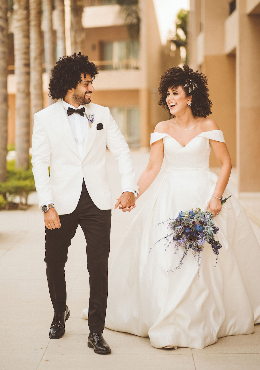 couple walking hand in hand at romantic and intimate wedding in egypt