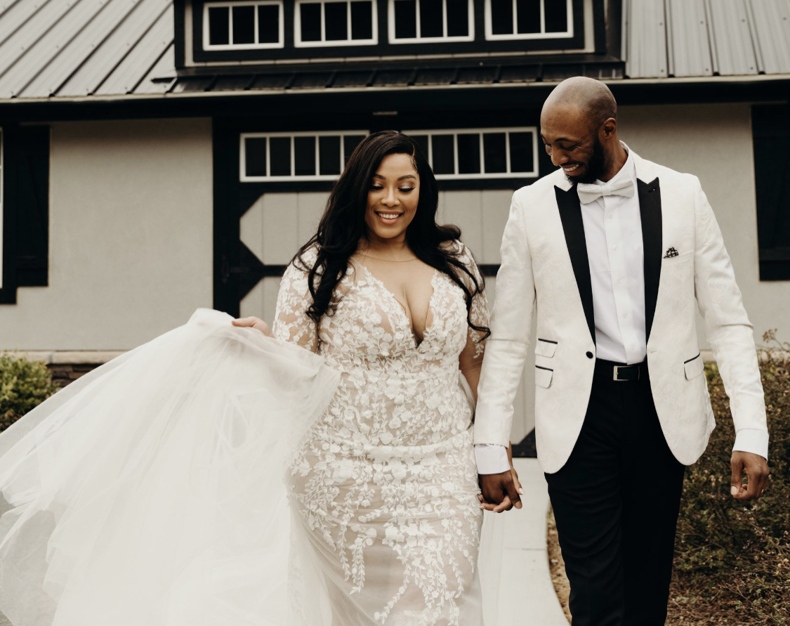 bride and groom walking hand in hand at sexy bohemian wedding