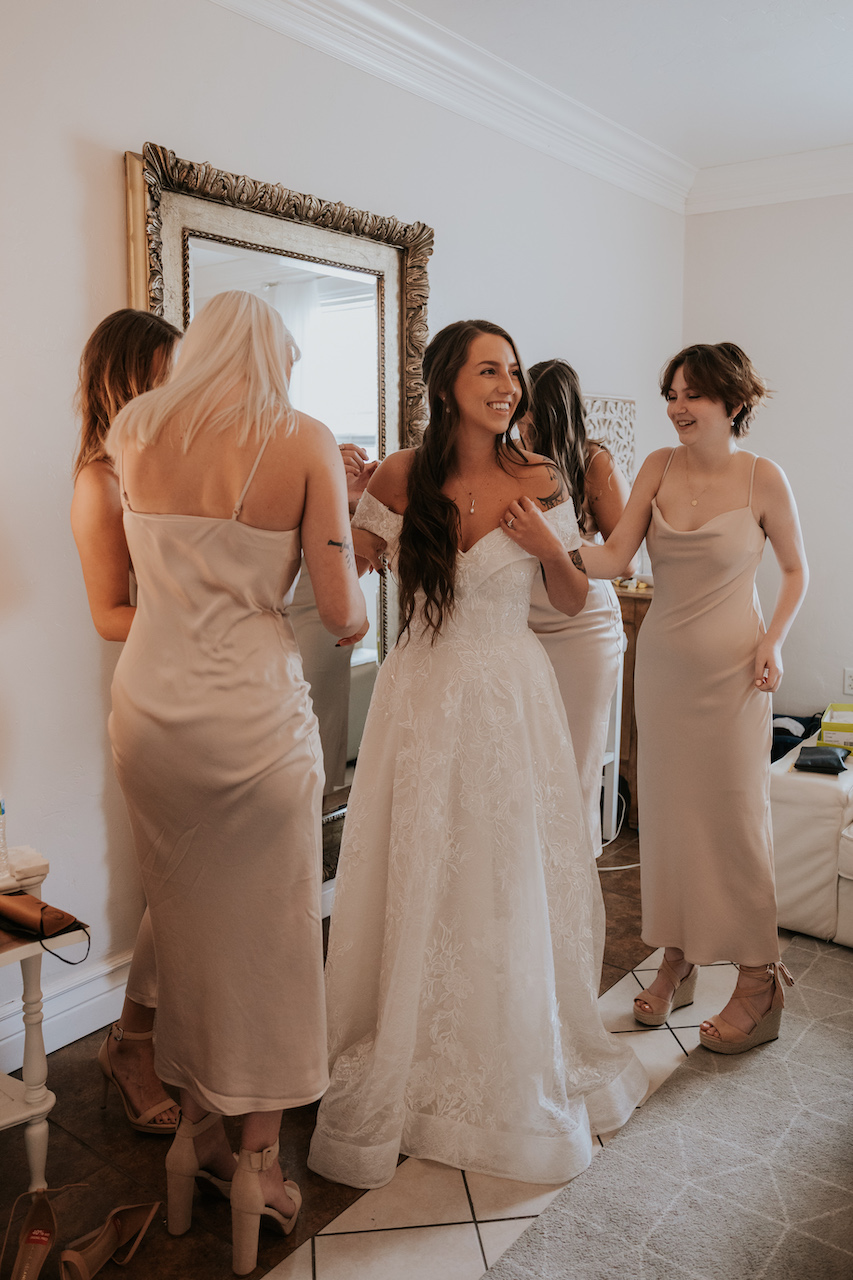 bride and bridesmaids getting ready at simple and elegant greenhouse wedding