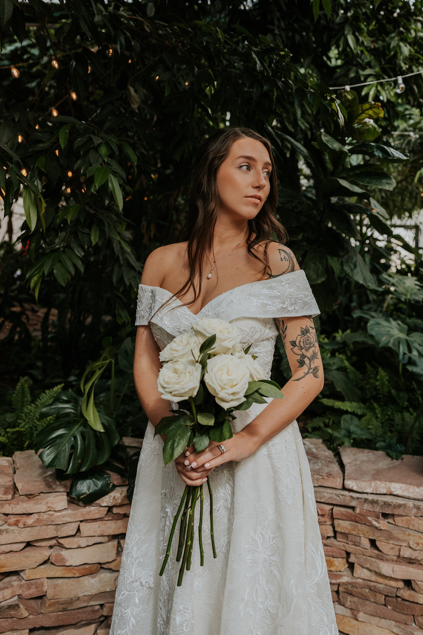 bride in wedding dress at simple and elegant greenhouse wedding