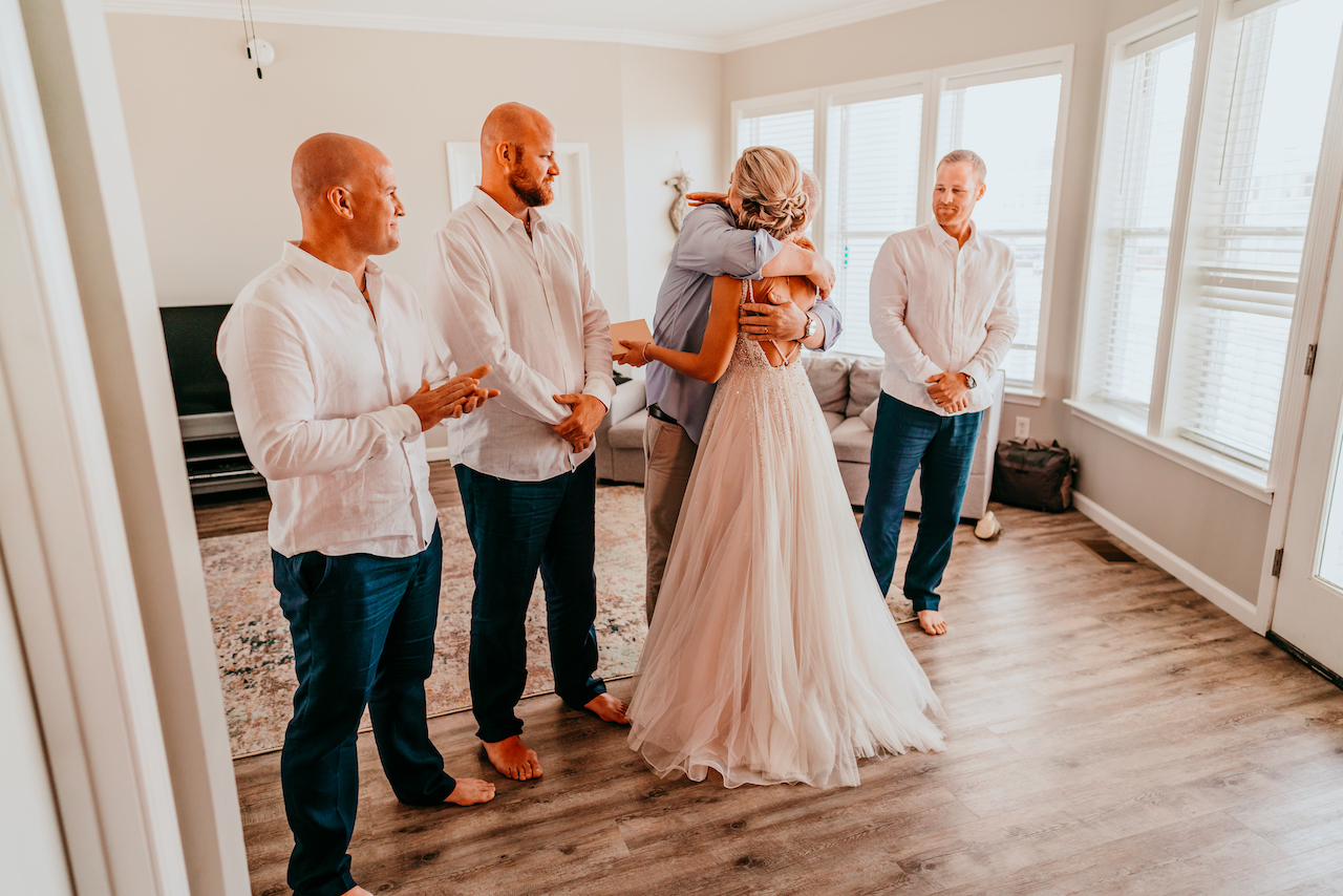 first look with bride, dad, and brothers 