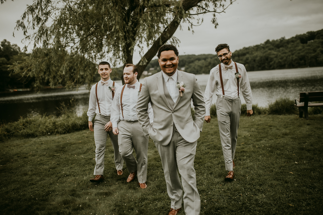 groom and groomsmen at rustic outdoor wedding