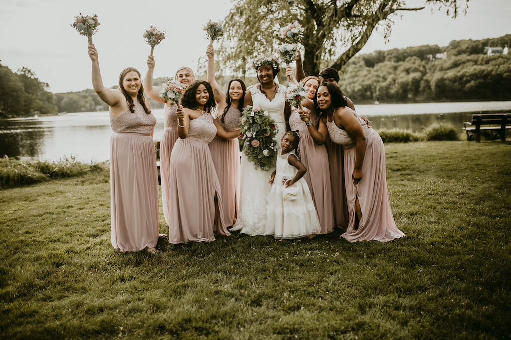 bride and bridesmaids at rustic outdoor wedding