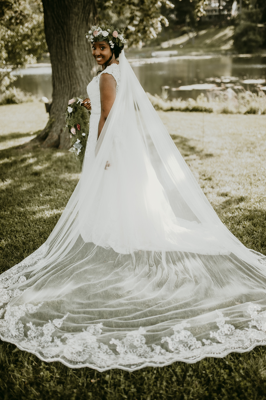 bride wearing lace wedding dress at rustic outdoor wedding 