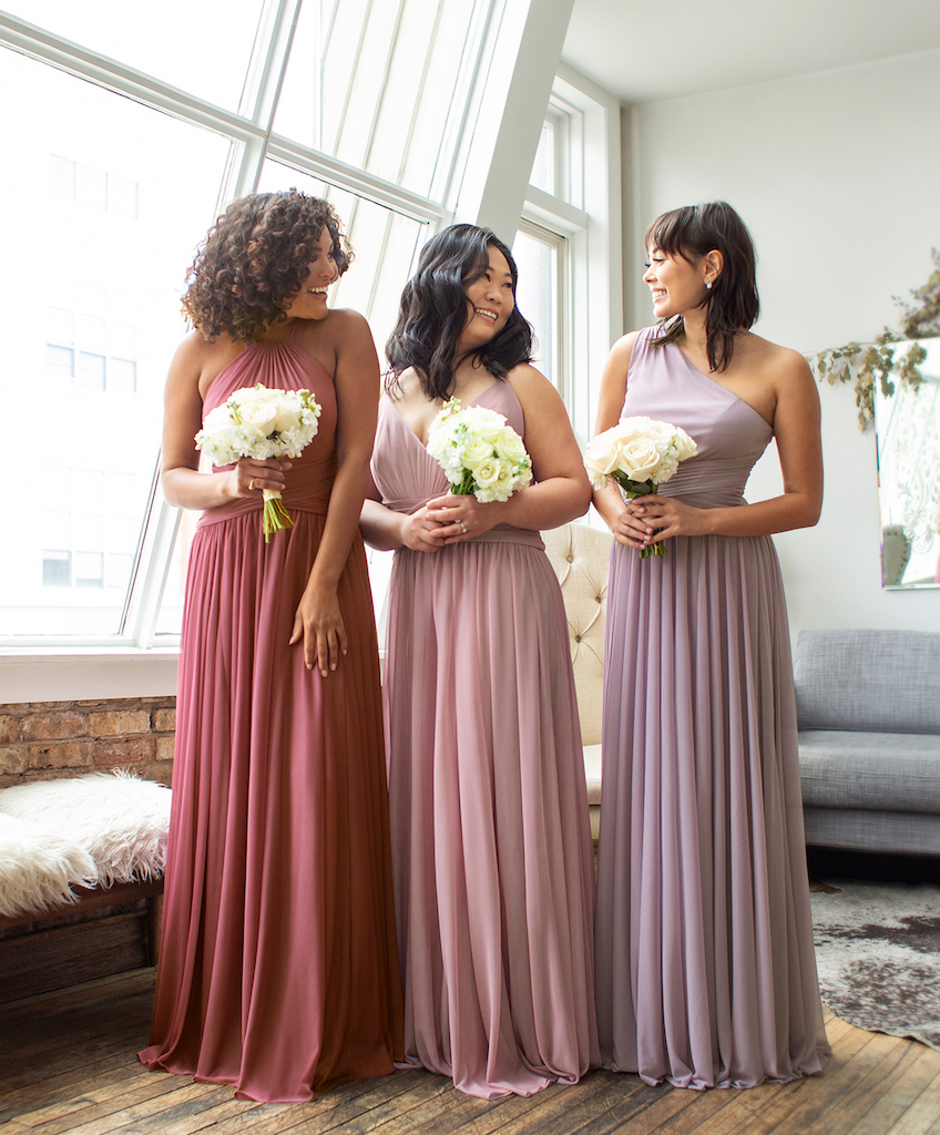 3 bridesmaids wearing purple mix and match bridesmaid dresses