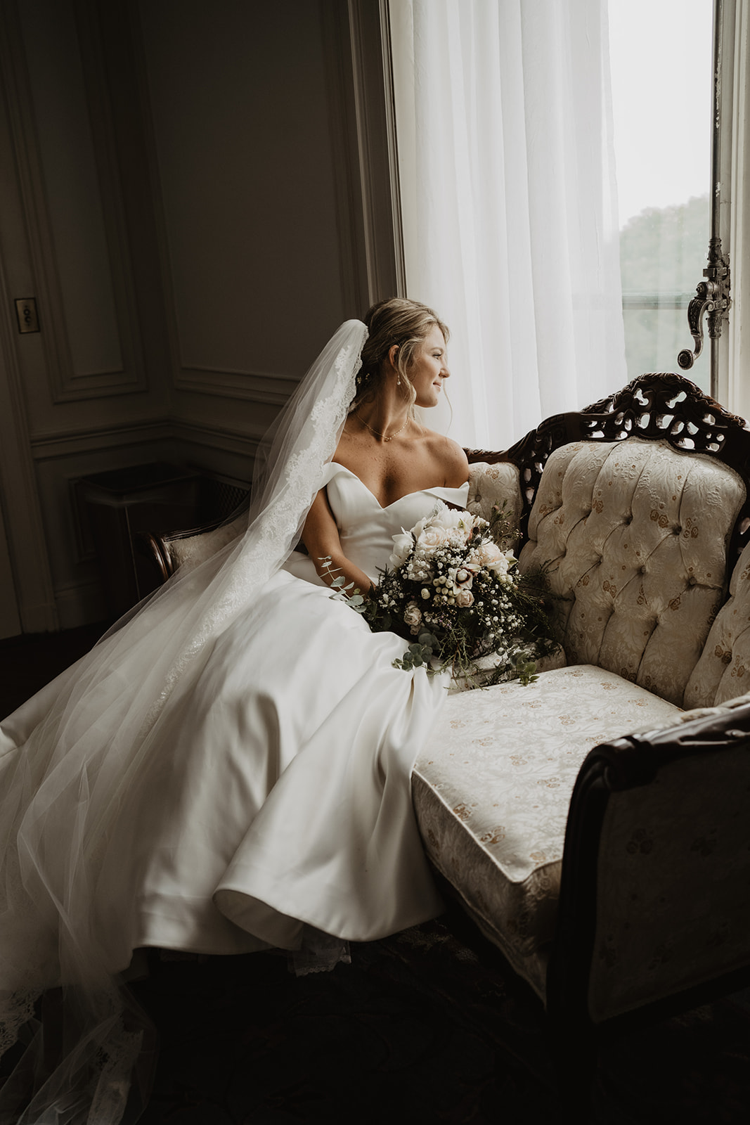 bride sitting on vintage couch