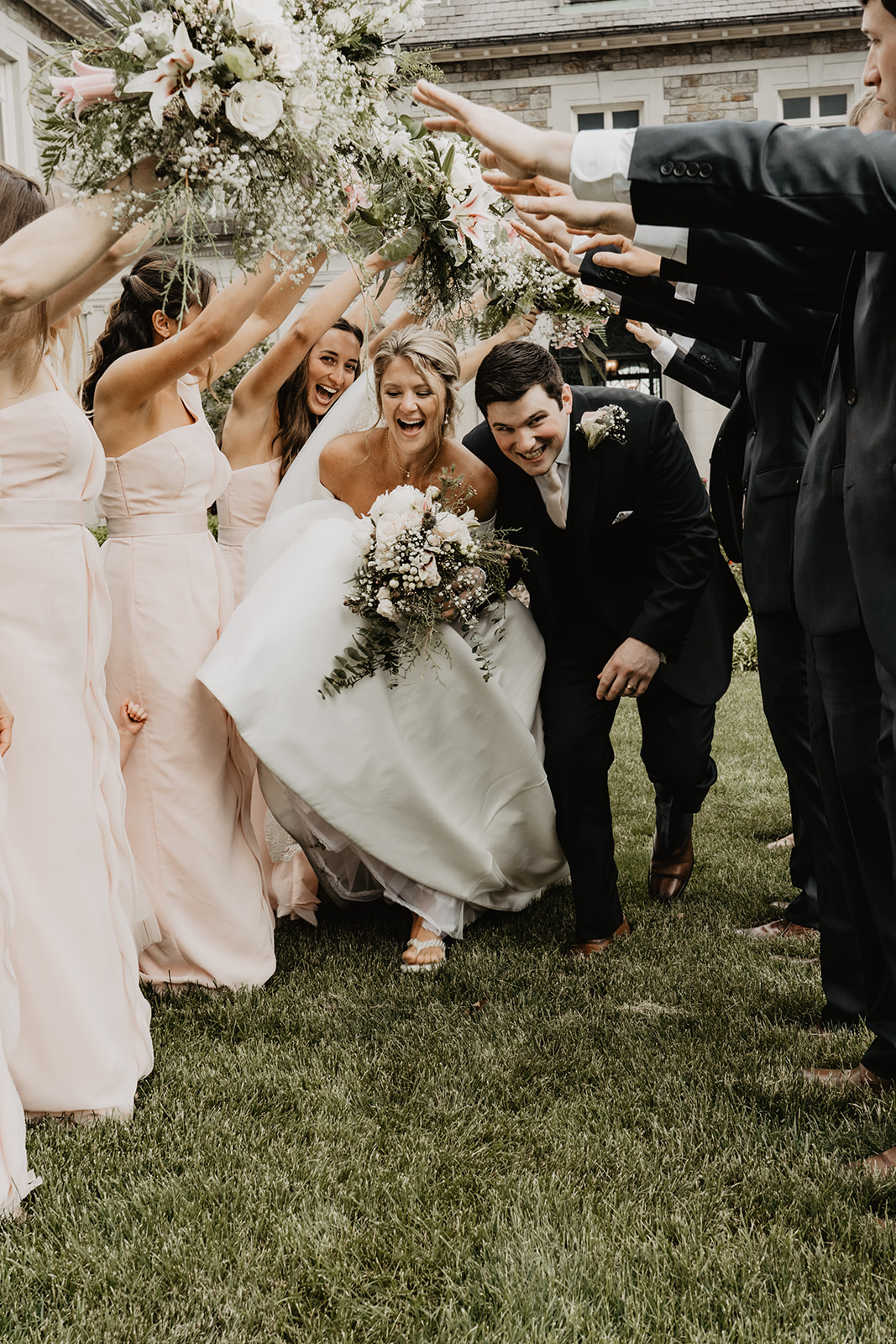 Bride and groom celebrating with bridal party 