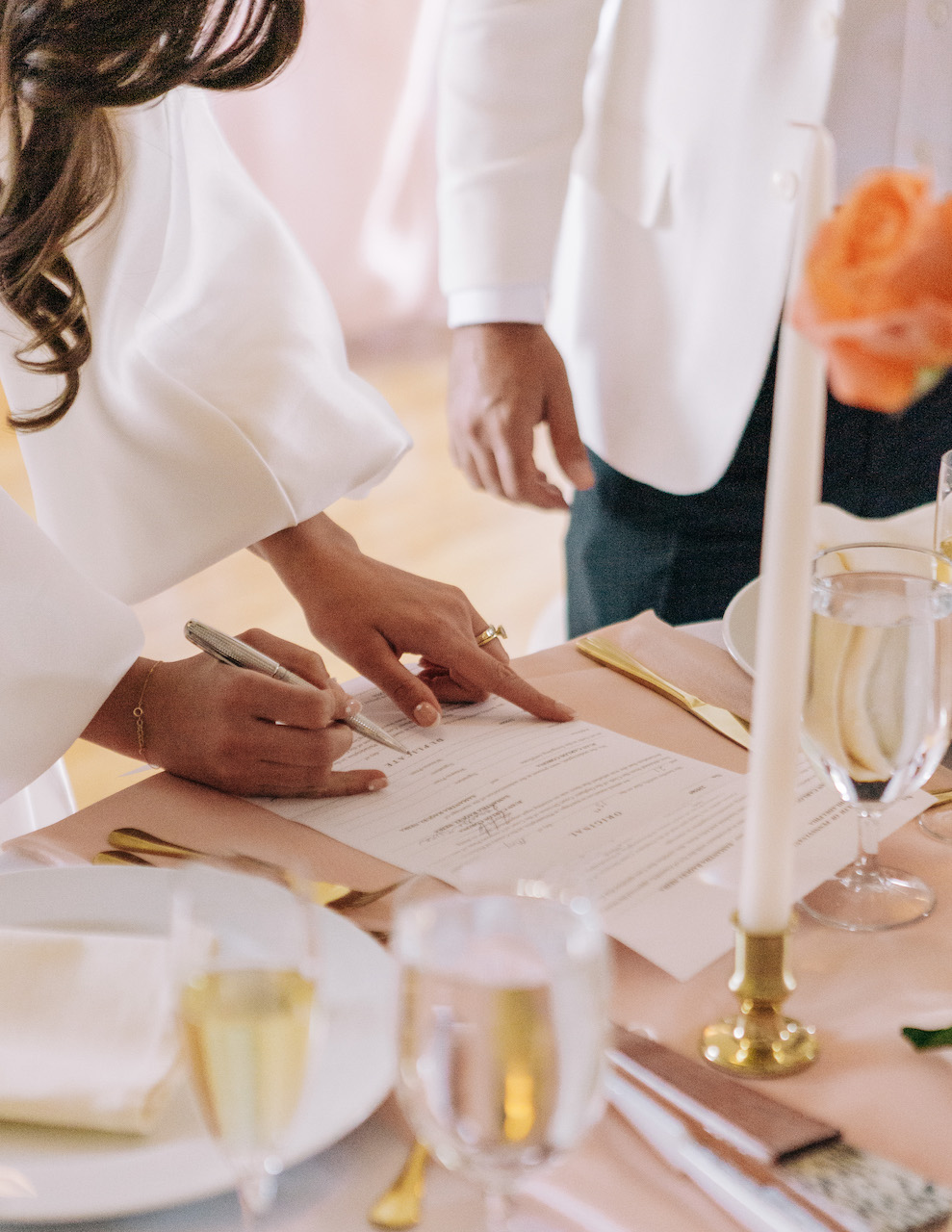 bride and groom signing wedding license