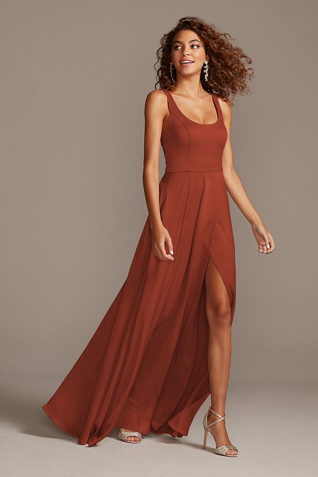 Woman in a satin bridesmaid gown with a leg slit and statement jewelry