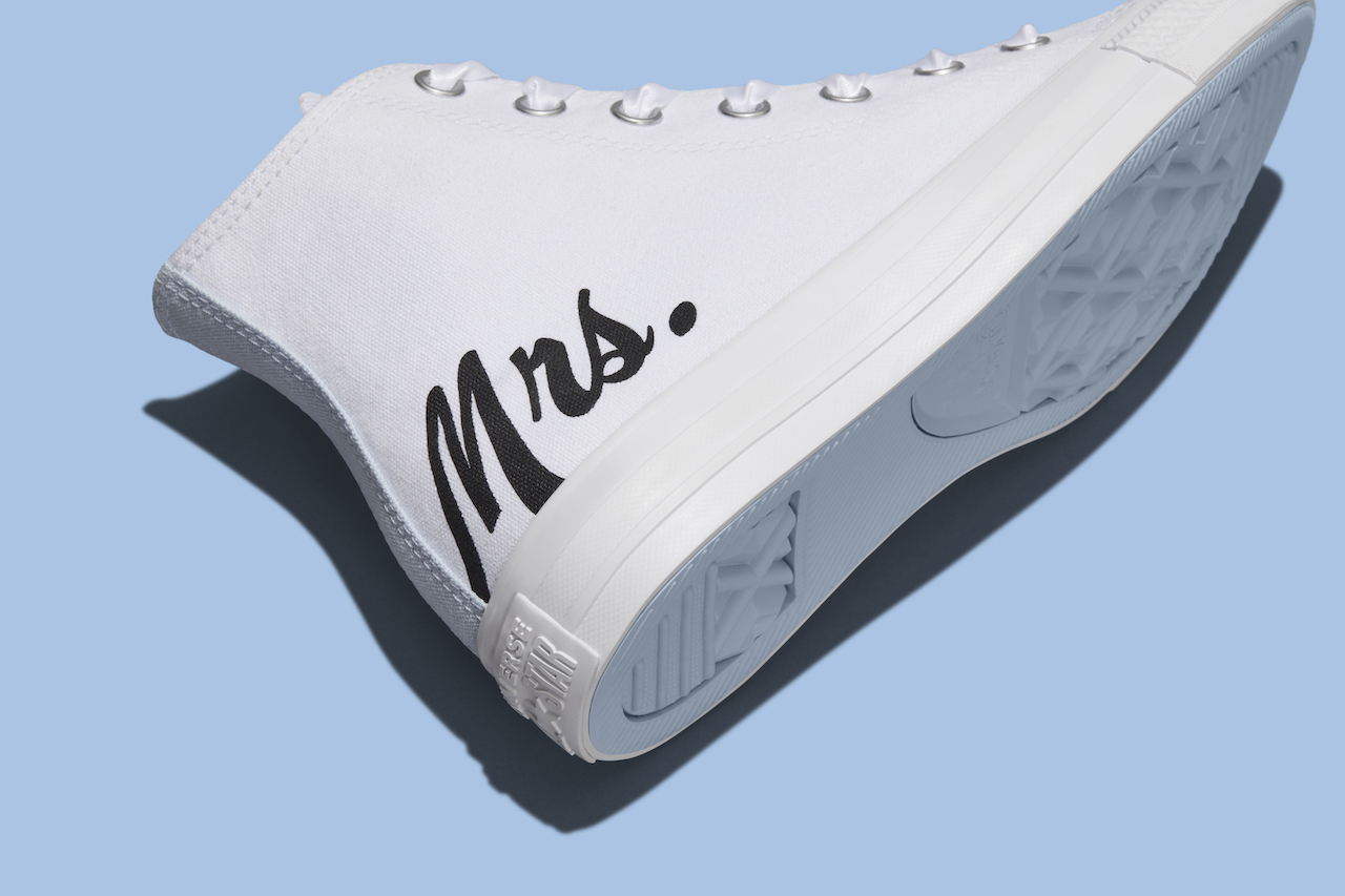 white pair of custom wedding shoes with the writing "mrs."