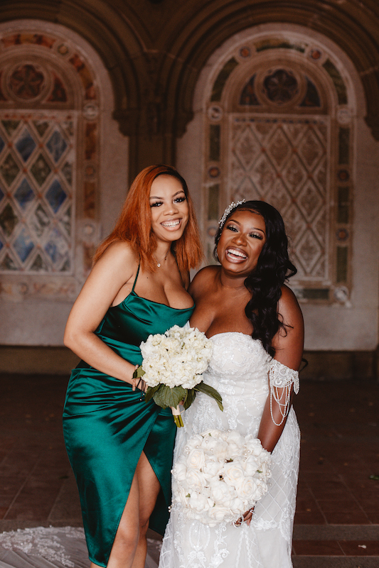 bride and bridesmaid smiling at wedding in new york city