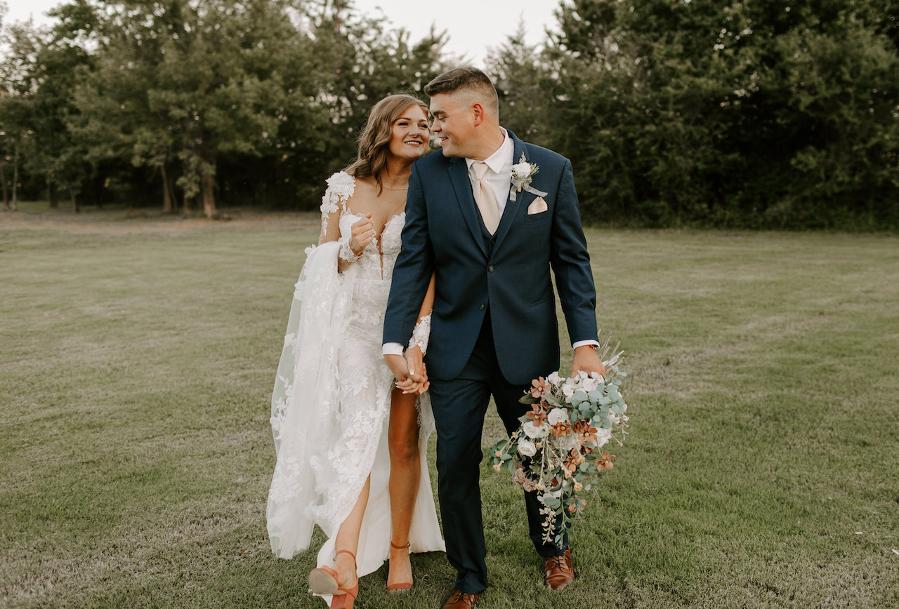 bride and groom walking hand in hand