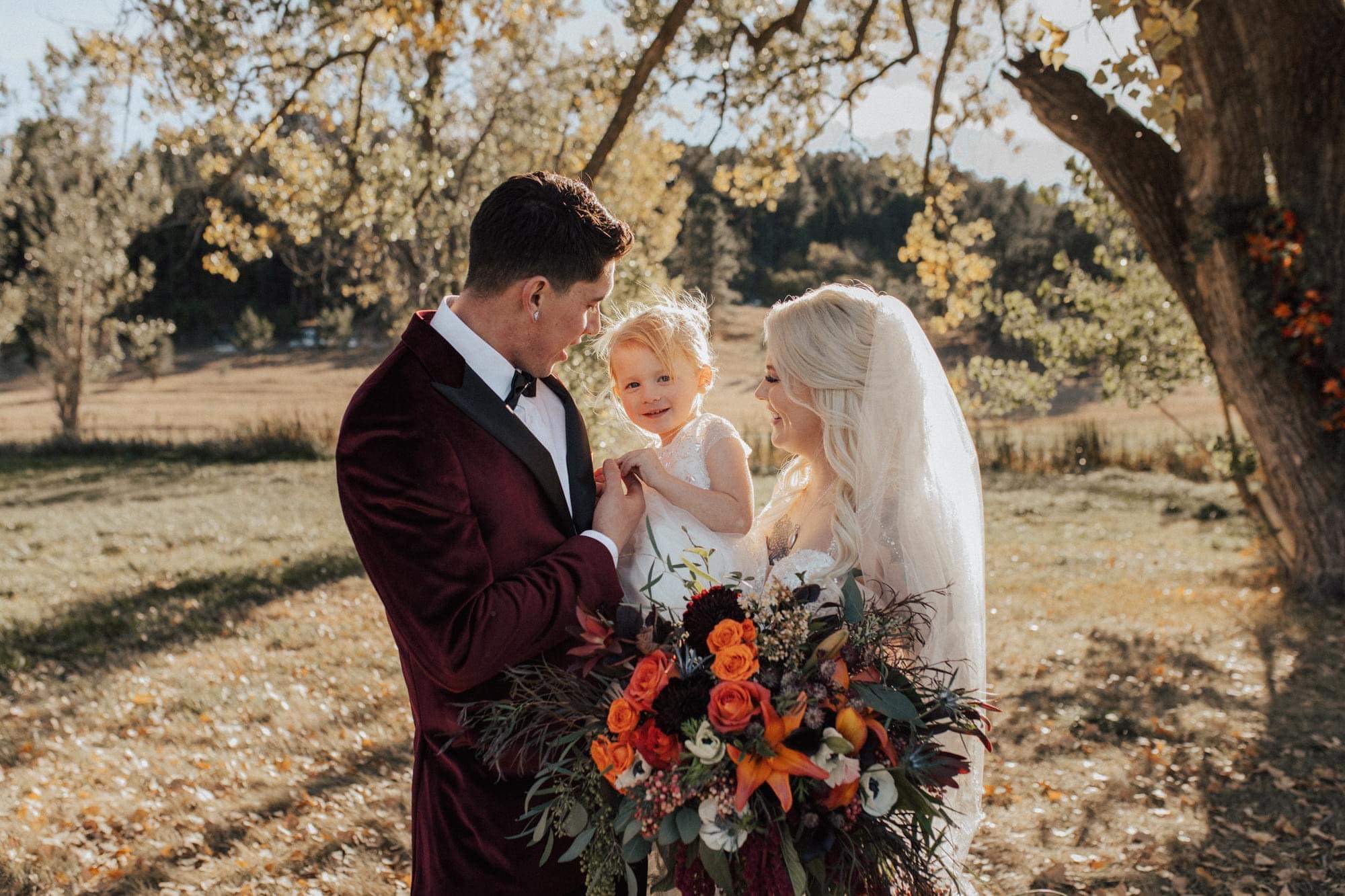 bride, groom, and their daughter 