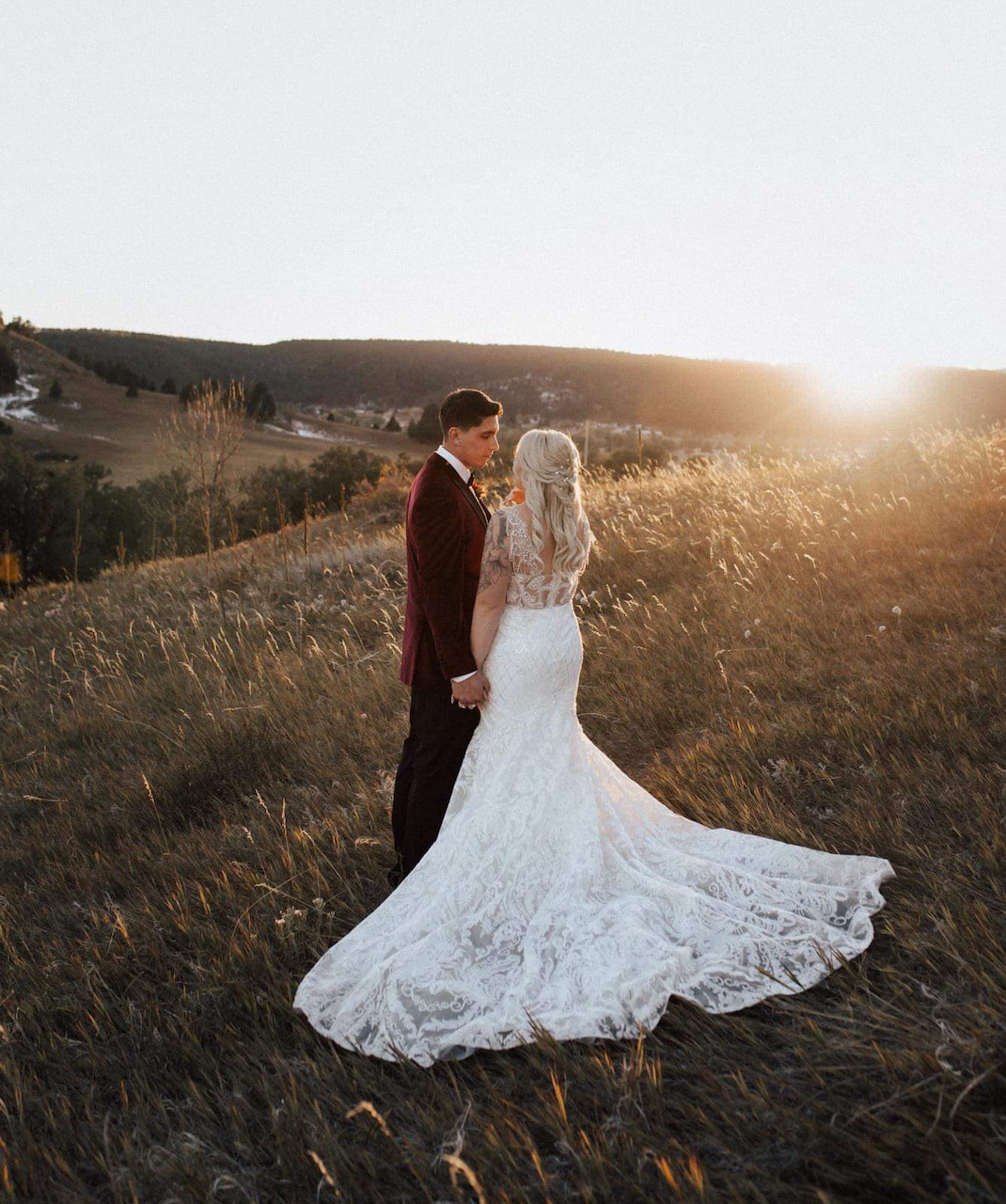 bride and groom looking at sunset 