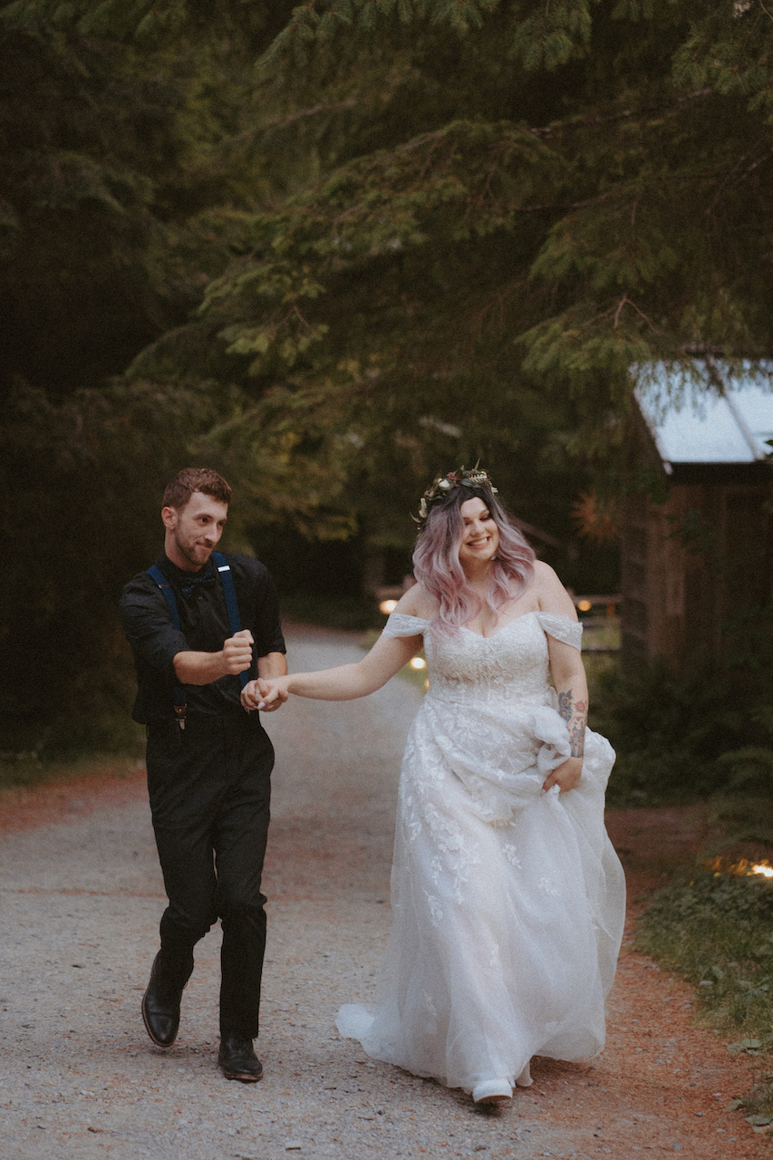 bride and groom running at wedding in mount rainer