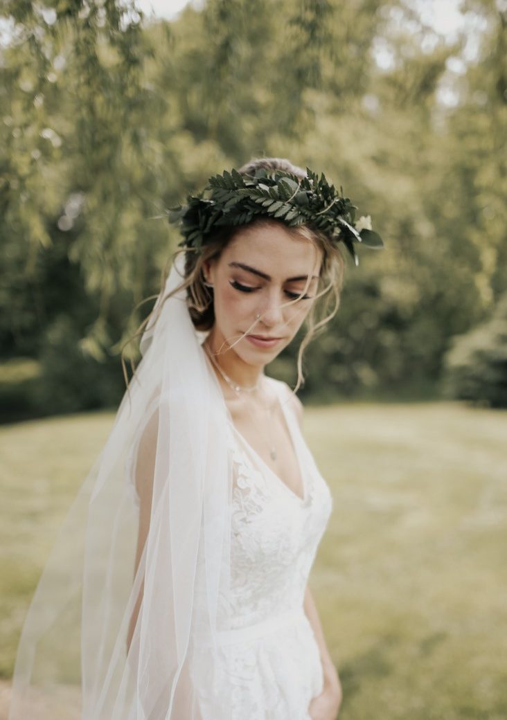 bride wearing a floral crown with greenery