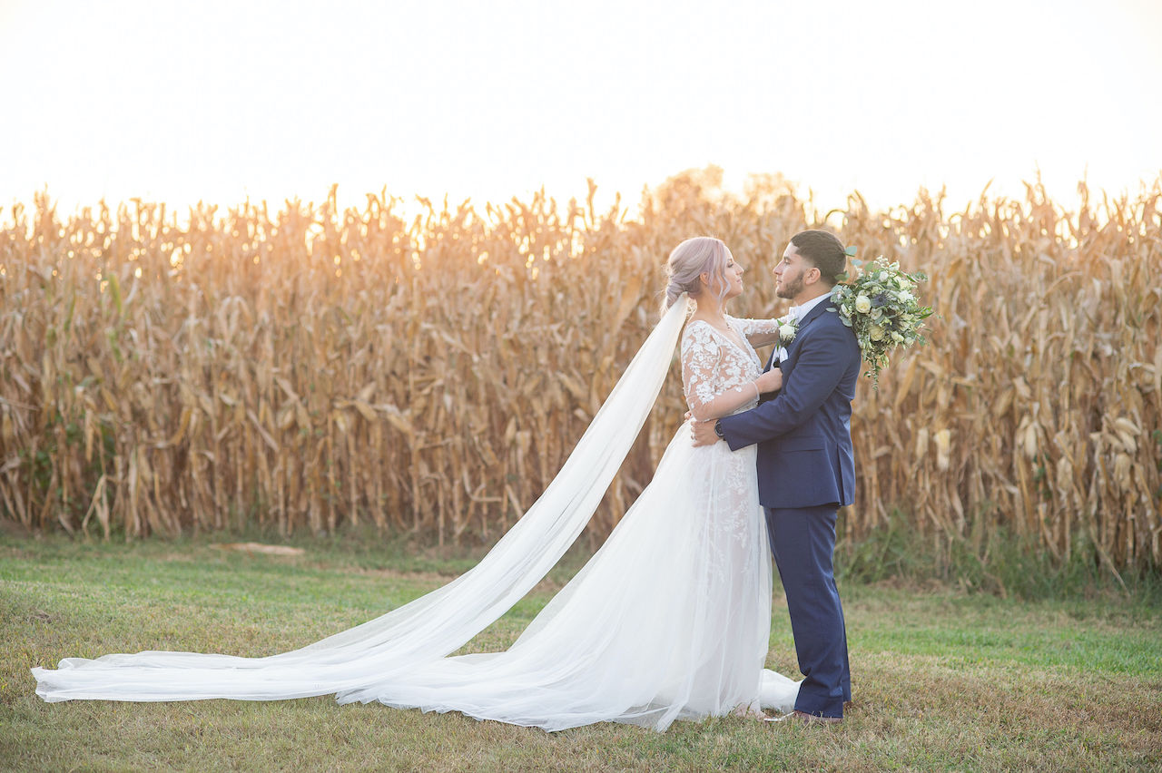 Bride and groom embracing each other at rustic outdoor wedding in Delaware