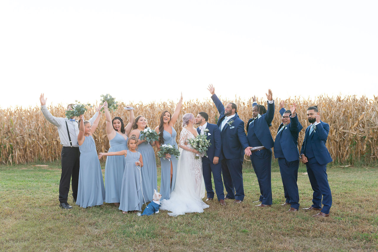 Wedding party celebrating at rustic outdoor wedding in Delaware
