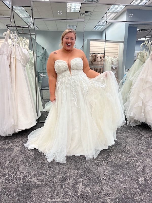 A plus-size bride wearing a strapless wedding dress