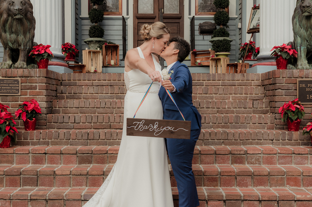 couple holding thank you sign