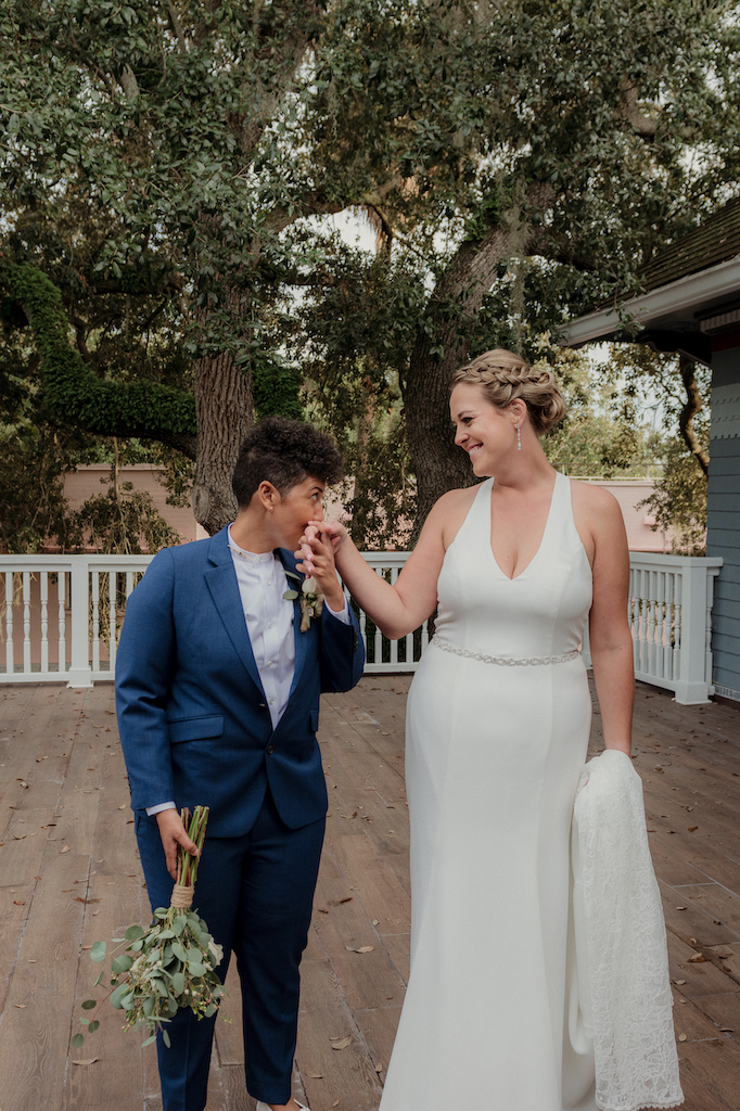 maria kissing Aislinn's hand - fall wedding in florida