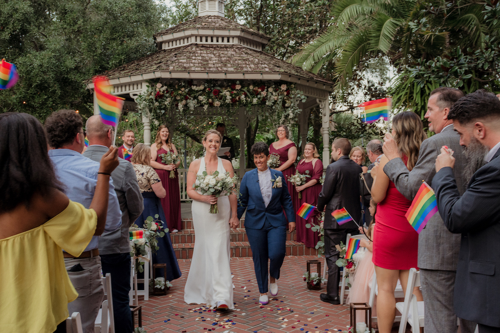 couple walking up aisle - fall wedding in florida