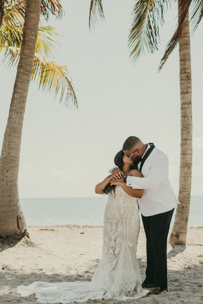 bride and groom kissing at tropical wedding in florida