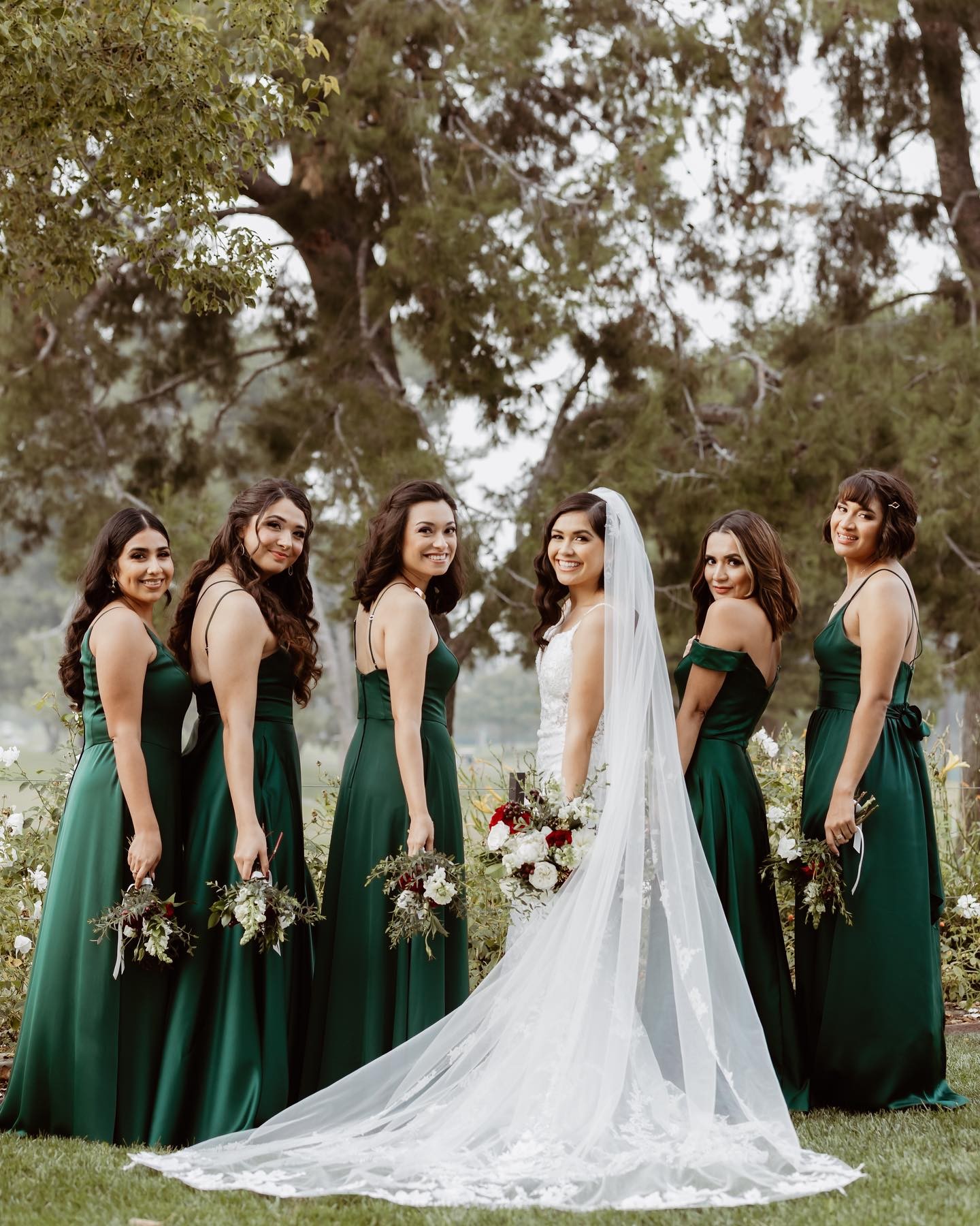 bridal party wearing green bridesmaid dresses