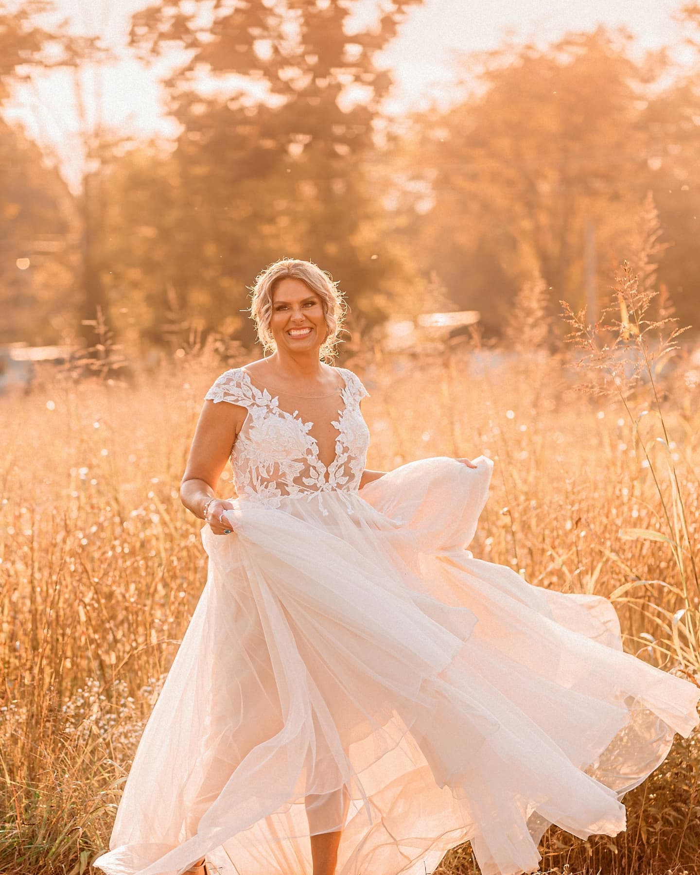 Illusion Cap Sleeve Lace Appliqued Wedding Dress - bride in a field at golden hour