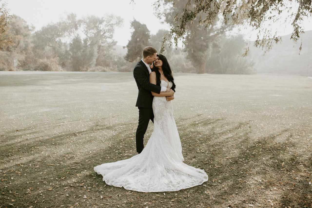 bride and groom embracing - ranch wedding in california